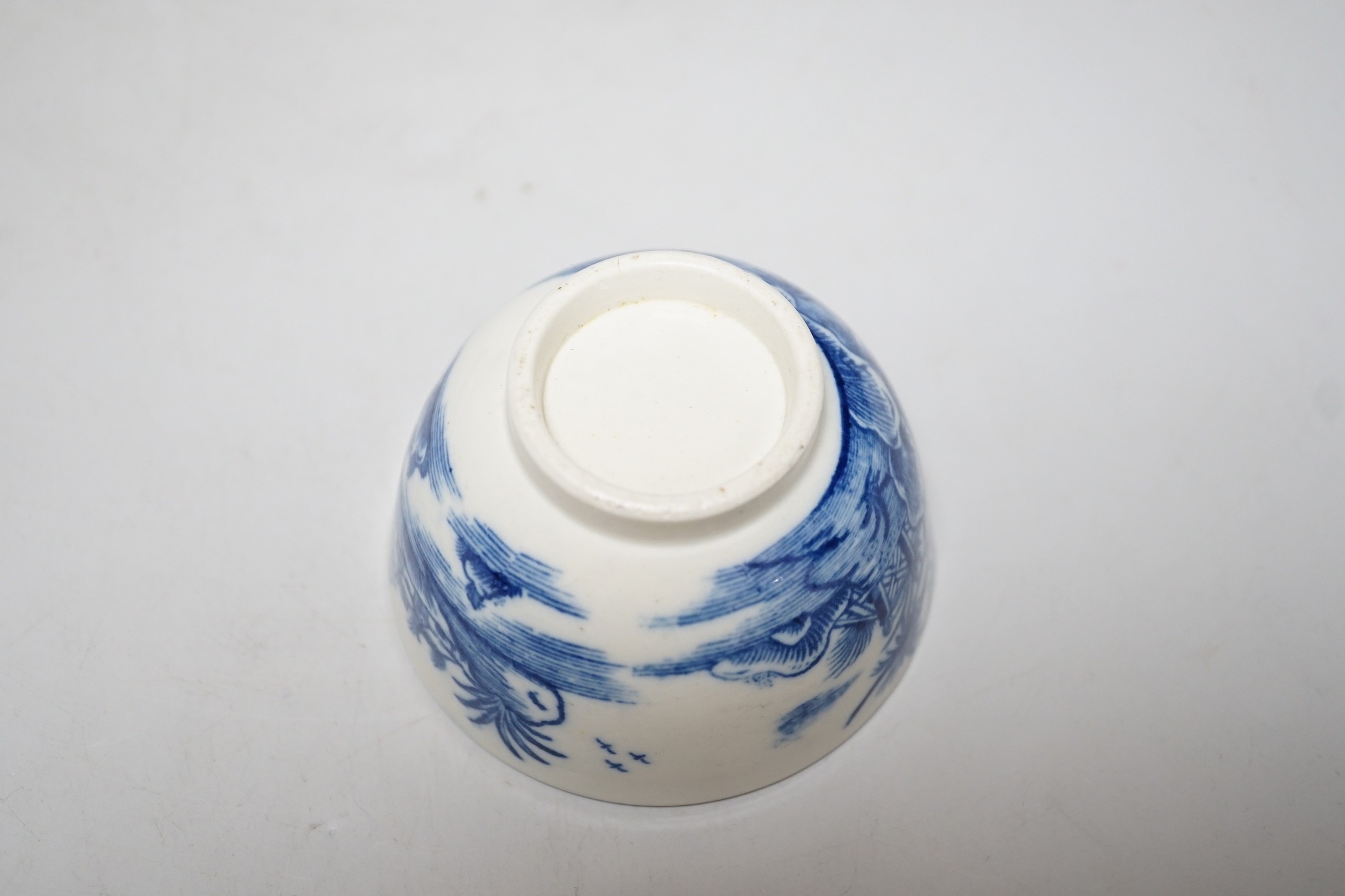 An 18th century Caughley teabowl and saucer printed with the uncommon Fence and House pattern. 6cm tall overall